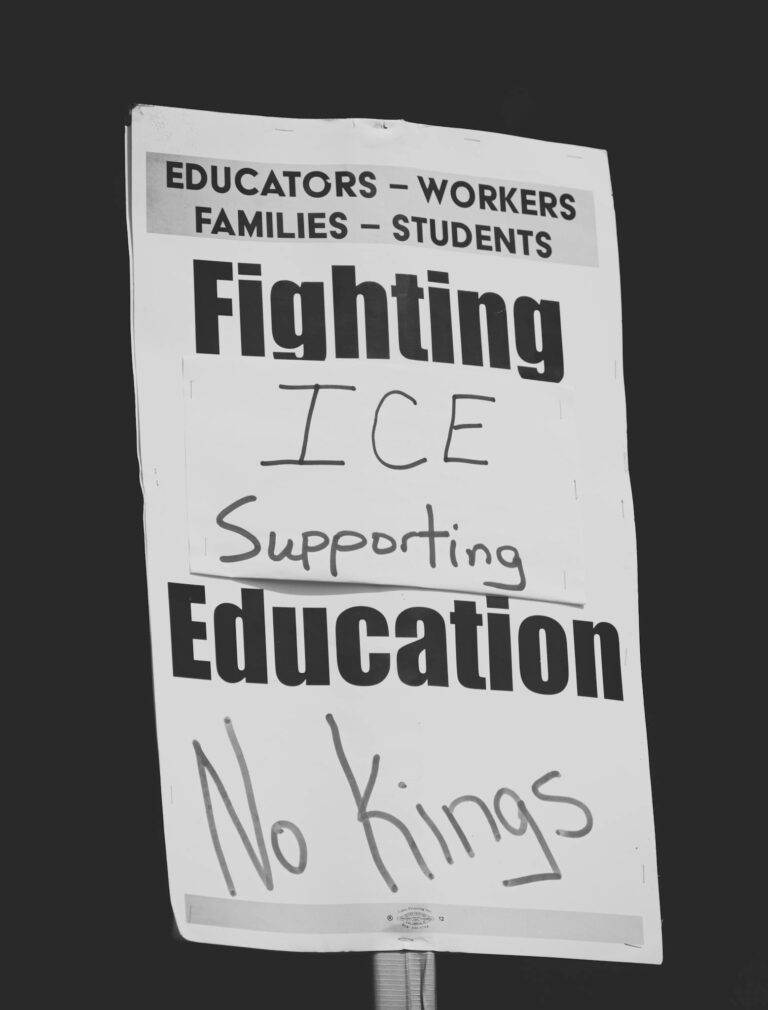 A protest sign highlighting issues with ICE and advocating for education reform.